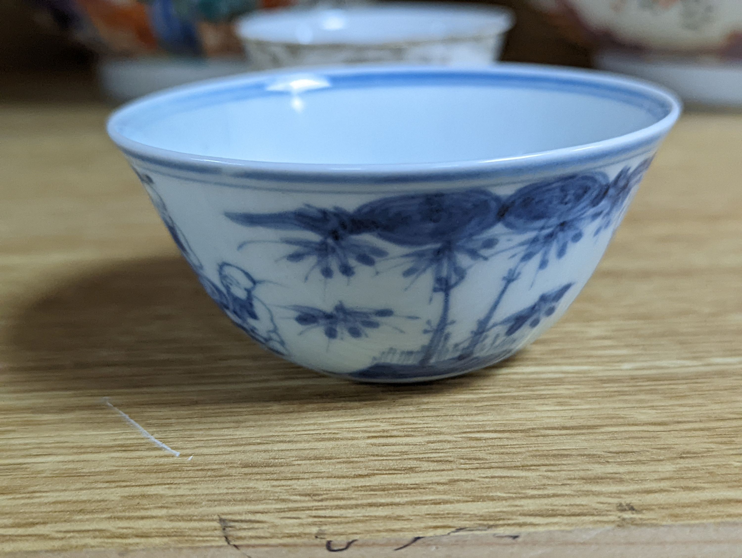 Two 18th century Chinese export bowls, a similar tea bowl and another Chinese blue and white tea bowl, largest 20cm diameter